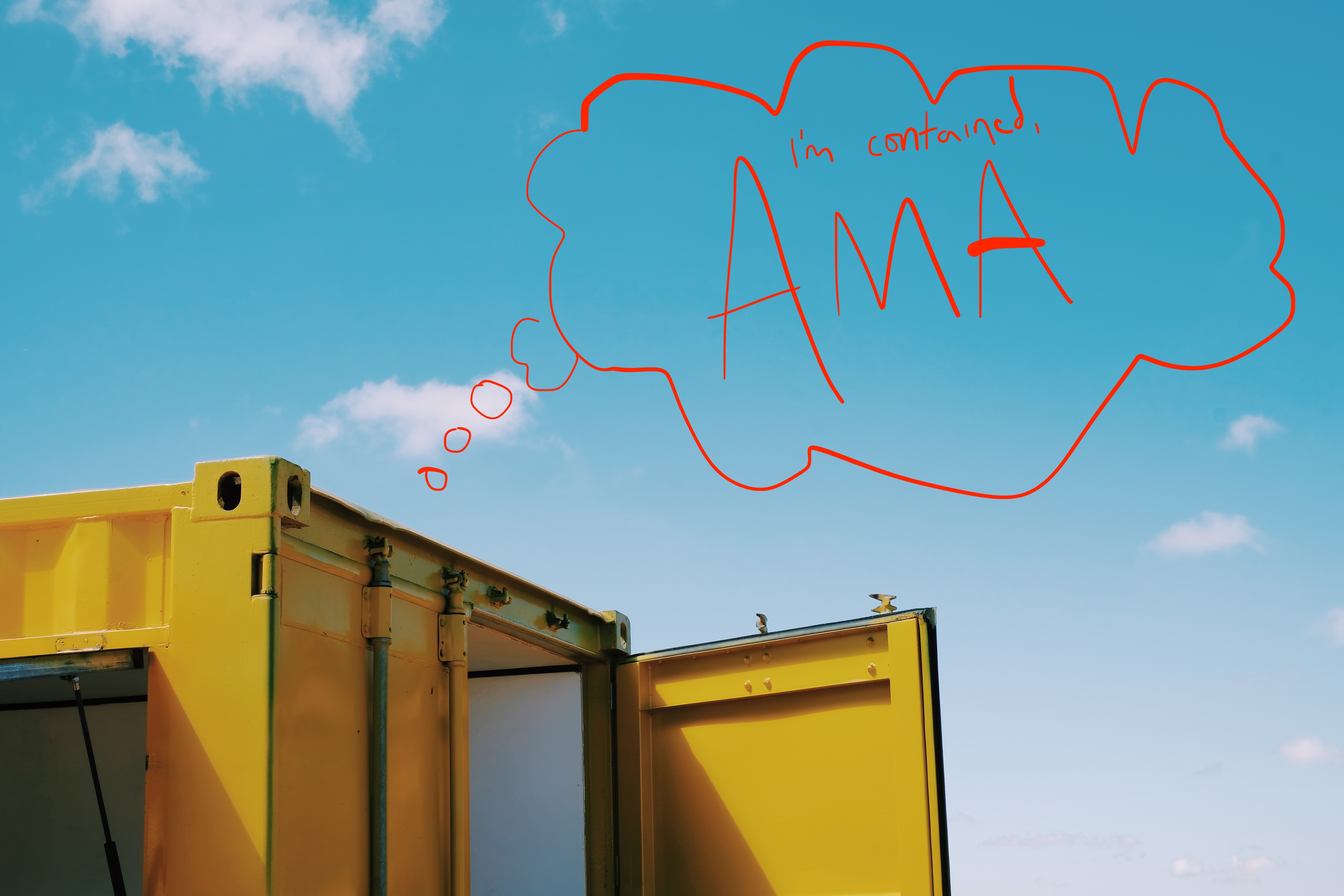 Yellow shipping container
with a red hand-written speech bubble:
I'm contained, AMA
