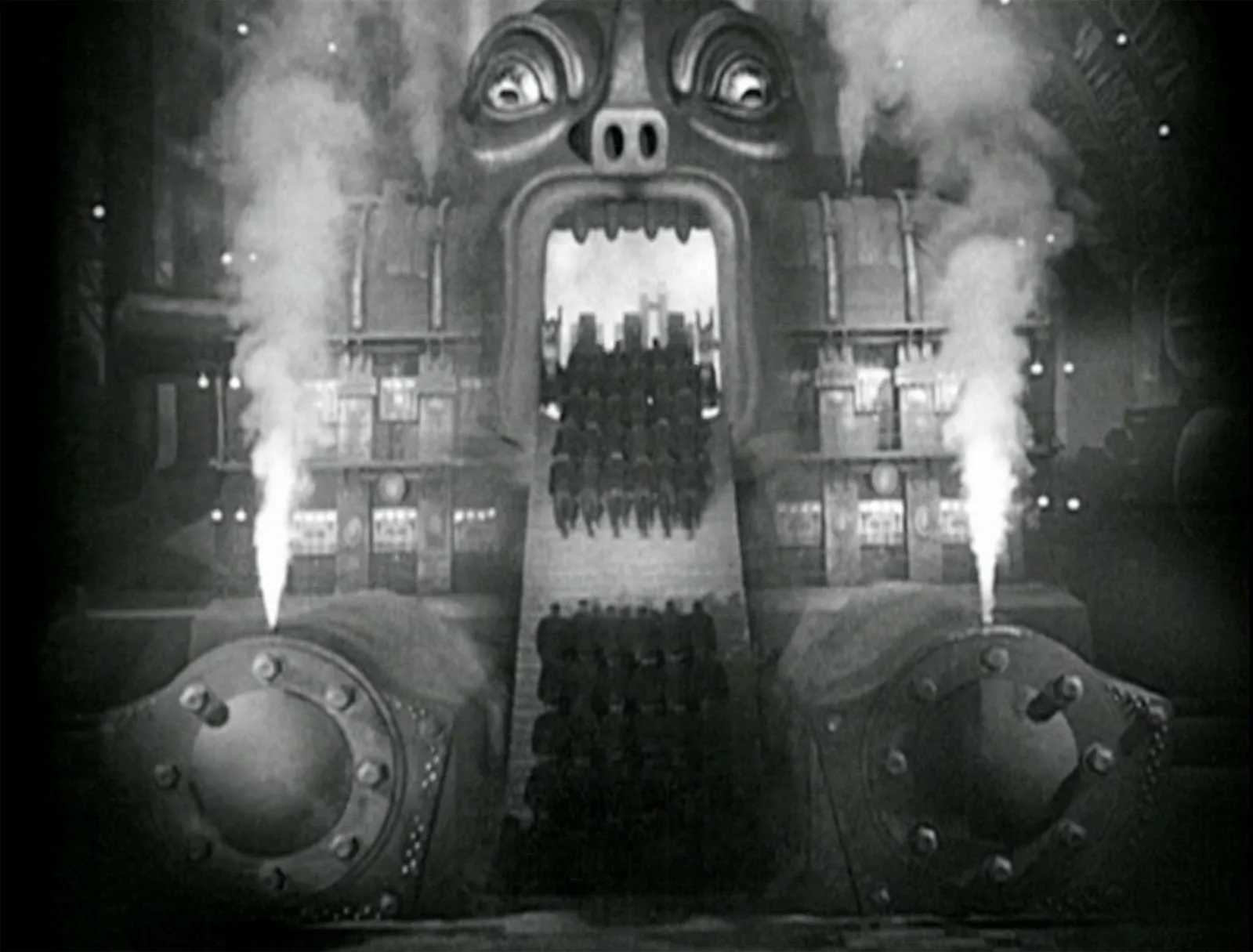 footage from Metropolis
with people climbing the stares
into the mouth of Moloch
a giant machine with glowing eyes
