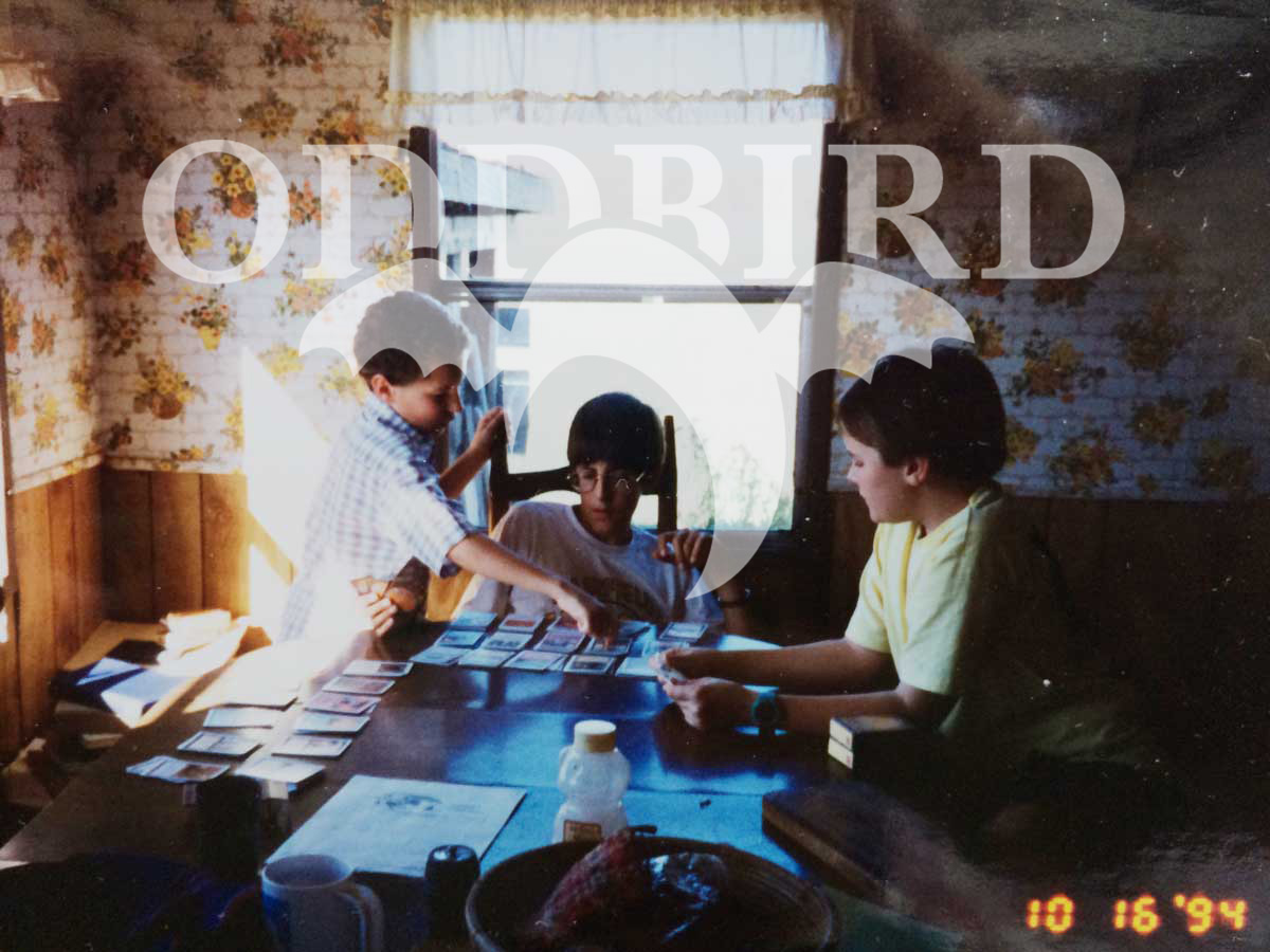 OddBird logo imposed over three children playing Magic The Gathering