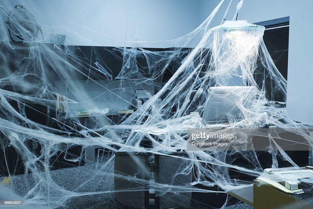 A gray office covered in cobwebs,
and a gettyImages watermark.
